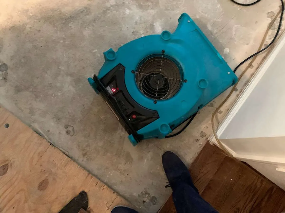 Air mover drying subfloor during Commercial Water Damage Restoration in Apple Valley